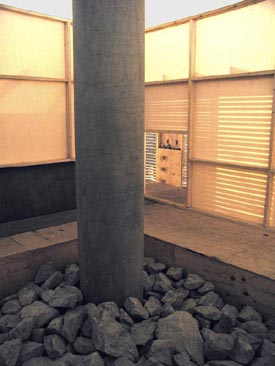 Canvas-screened inner sanctum isolating a single column from Corbusier's grid of piloti